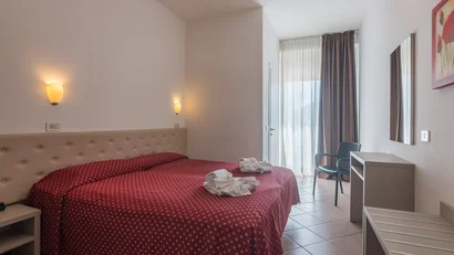 Camera d'albergo con letto matrimoniale e decorazioni da bagno piegate